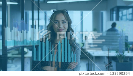 Standing woman in striped blazer analyzing blue bar charts on digital display in open-plan office Standing woman in striped blazer analyzing blue bar charts on digital display in open-plan office 135590294
