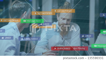 Leading discussion bearded man in casual shirt in tech office with laptops phone mug notifications Leading discussion bearded man in casual shirt in tech office with laptops phone mug notifications 135590331