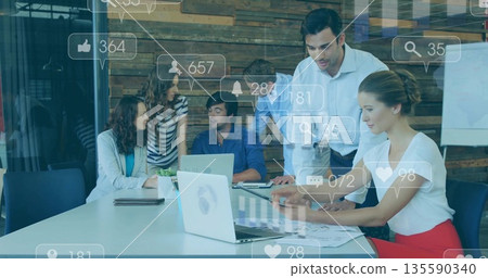 Pointing man in white shirt leading social media discussion at conference room table, with laptops Pointing man in white shirt leading social media discussion at conference room table, with laptops 135590340