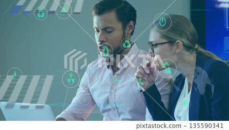 Reviewing energy data on laptop at office, two professionals wearing blazer with holographic icons Reviewing energy data on laptop at office, two professionals wearing blazer with holographic icons 135590341