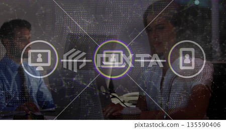 Working staff wearing suits using desktop and laptop at office desk, with network icons overlay Working staff wearing suits using desktop and laptop at office desk, with network icons overlay 135590406