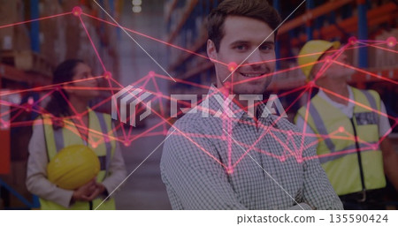 Supervising manager guiding team in warehouse aisle, with vests, shelves, boxes, network overlay Supervising manager guiding team in warehouse aisle, with vests, shelves, boxes, network overlay 135590424