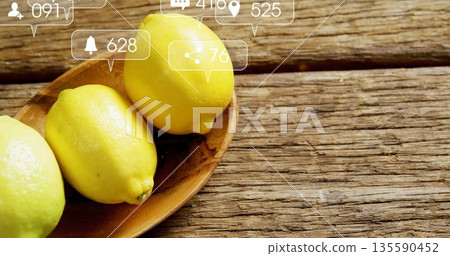 Resting three yellow lemons in bowl on rustic kitchen table overlaid social media icons copy space Resting three yellow lemons in bowl on rustic kitchen table overlaid social media icons copy space 135590452