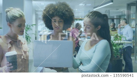 Collaborating three women in business attire reviewing laptop screen at office with coffee cup Collaborating three women in business attire reviewing laptop screen at office with coffee cup 135590541