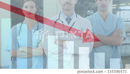 Three medics in scrubs standing cross-armed at hospital, stethoscopes showing declining bar overlay Three medics in scrubs standing cross-armed at hospital, stethoscopes showing declining bar overlay 135590571