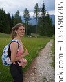 Woman Hiker Smiling on Mountain Path 135590785
