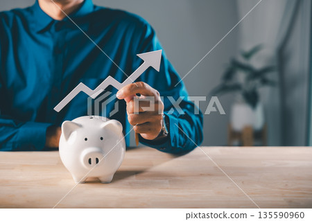 Piggy bank economy increase money wealth gambling pig report saving investments strategy shows growth as businessman holds white rising arrow for financial budget success planning Piggy bank economy increase money wealth gambling pig report saving investments strategy shows growth as businessman holds white rising arrow for financial budget success planning 135590960