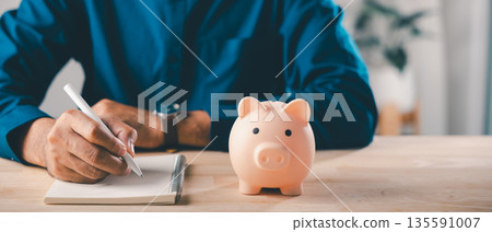 saving for college career growth with piggy bank learning education, man writing in notebook planning budget for student, investment for professional future and success goals 135591007