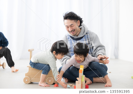 Nursery school and kindergarten teachers and children, teachers playing with building blocks Nursery school and kindergarten teachers and children, teachers playing with building blocks 135591395
