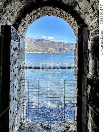 scenic seaside arch, idyllic seaside landscape showcasing charming stone arch overlooking calm waters 135591477