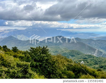 Stunning Mountain Landscape Under Dramatic Clouds Captivates the Eye with Its Beauty Stunning Mountain Landscape Under Dramatic Clouds Captivates the Eye with Its Beauty 135591491