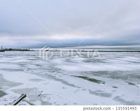 A snowy landscape with an overcast sky, offering a serene winter beauty for outdoor adventures 135591493