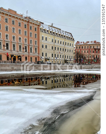 An Enchanting Winter Cityscape Featuring Stunning Reflections on a Beautiful Icy Water Surface An Enchanting Winter Cityscape Featuring Stunning Reflections on a Beautiful Icy Water Surface 135591547