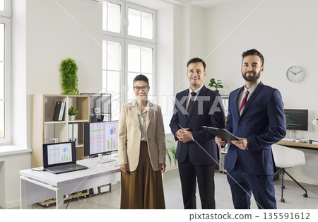 Confident business team in modern office, leadership and teamwork concept Confident business team in modern office, leadership and teamwork concept 135591612