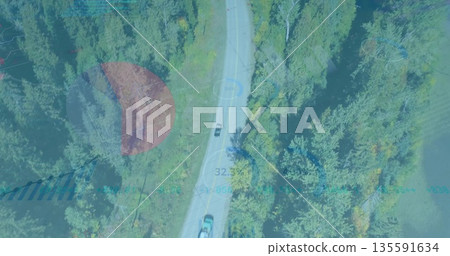 Driving dark-colored SUV navigating paved forest road, with sedan and digital telemetry overlays 135591634