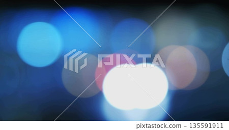 Displaying abstract bokeh pattern shimmering across dark background, with colorful circular lights Displaying abstract bokeh pattern shimmering across dark background, with colorful circular lights 135591911