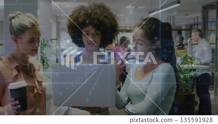 Collaborating women wearing business attire checking laptop in office, with disposable coffee cup Collaborating women wearing business attire checking laptop in office, with disposable coffee cup 135591928