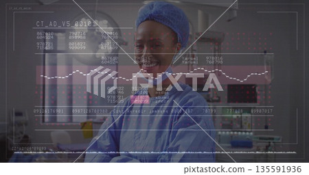 Smiling doctor in surgical scrubs examining numeric codes and waveforms overlay in surgical suite Smiling doctor in surgical scrubs examining numeric codes and waveforms overlay in surgical suite 135591936