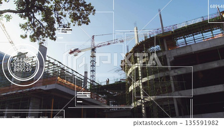 Standing construction workers wearing helmets vests on scaffolding at job site, with tower crane Standing construction workers wearing helmets vests on scaffolding at job site, with tower crane 135591982