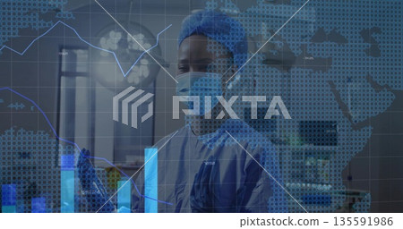 Medical professional wearing surgical gear analyzing data in surgical room with transparent display 135591986