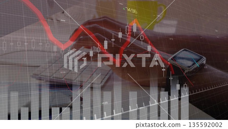 Typing hands in sleeves on laptop keyboard at office desk, with green mug, smartwatch and charts 135592002