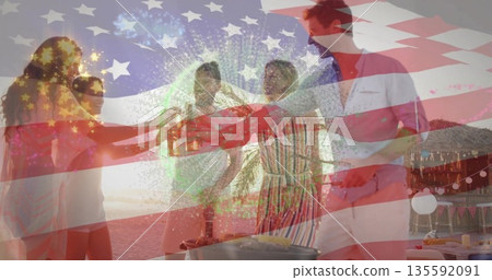 Toasting five friends holding beer bottles on beach at sunset, with tiki hut, grill, flag overlay Toasting five friends holding beer bottles on beach at sunset, with tiki hut, grill, flag overlay 135592091