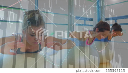 Three women wearing activewear holding plank lifts on yoga mats in fitness studio, with data charts Three women wearing activewear holding plank lifts on yoga mats in fitness studio, with data charts 135592115