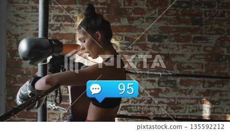 Leaning boxer in sportswear catching breath in ring, with gloves and comment bubble showing 95 135592212