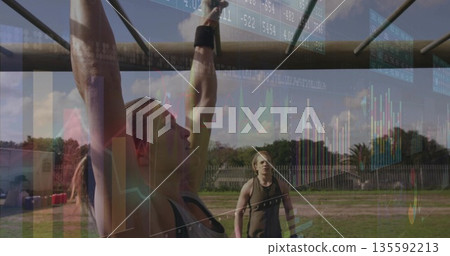 Pulling woman wearing tank top, wrist wraps on metal monkey bars in grassy backyard, copy space 135592213