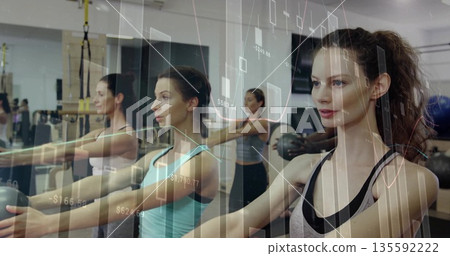 Front-right woman performing medicine ball chest presses in workout studio, with data overlays Front-right woman performing medicine ball chest presses in workout studio, with data overlays 135592222