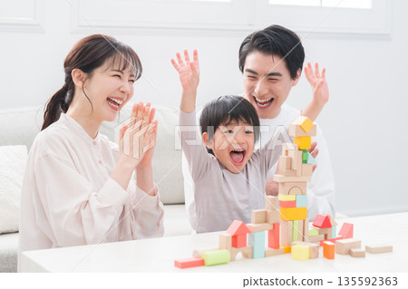 Family playing with building block toys Family playing with building block toys 135592363