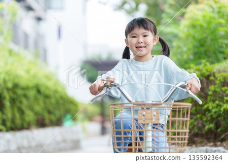 Child riding a bicycle during practice Child riding a bicycle during practice 135592364