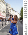 Woman Photographing City Scene with Camera 135592519
