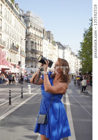 Woman Photographing City Scene with Camera Woman Photographing City Scene with Camera 135592519