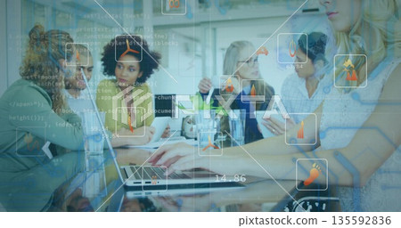 Using tablet and laptops team wearing casual wear analyzing code overlays in office with data icons Using tablet and laptops team wearing casual wear analyzing code overlays in office with data icons 135592836