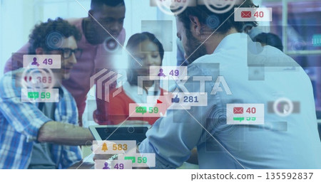 Reviewing team pointing at laptop screen in office meeting room, with floating notification icons Reviewing team pointing at laptop screen in office meeting room, with floating notification icons 135592837