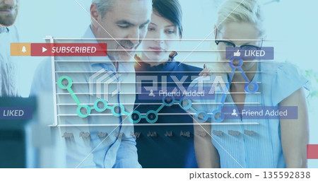 Examining team in shirts analyzing dashboard in office with SUBSCRIBED LIKED Friend Added icons Examining team in shirts analyzing dashboard in office with SUBSCRIBED LIKED Friend Added icons 135592838