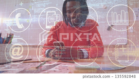 Mid adult man wearing sweatshirt holding smartphone analyzing charts in office, with digital icons 135592848