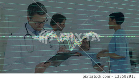 Examining physician wearing coat stethoscope with clipboard in patient room with overlay copy space 135592915