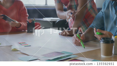 Brainstorming team mapping ideas on blank paper at office table with sticky notes and highlighters Brainstorming team mapping ideas on blank paper at office table with sticky notes and highlighters 135592931