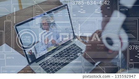 Displaying laptop hosting meeting at office desk, colleague holding mug, tablet with data overlays Displaying laptop hosting meeting at office desk, colleague holding mug, tablet with data overlays 135592947