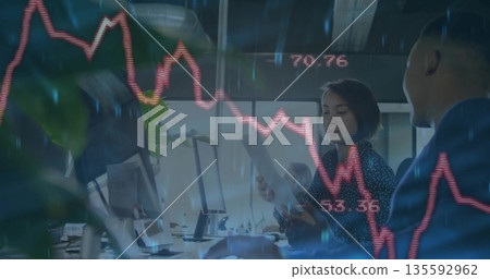 Female employee reviewing printed report with male coworker in office, with stock chart overlay Female employee reviewing printed report with male coworker in office, with stock chart overlay 135592962