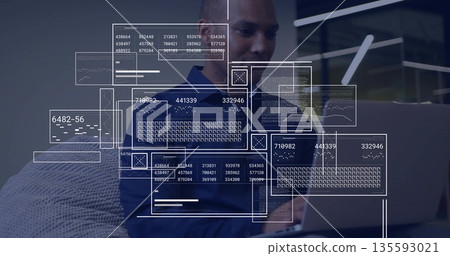 Typing man wearing blue polo shirt manipulating digital panels on silver laptop in office lounge Typing man wearing blue polo shirt manipulating digital panels on silver laptop in office lounge 135593021
