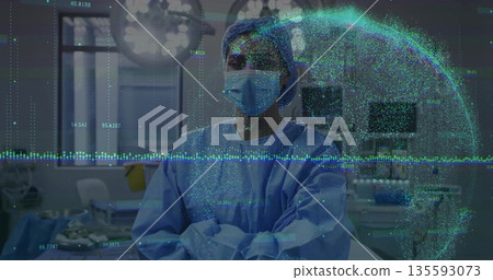 Surgeon wearing blue scrubs analyzing holographic globe in operating room with surgical lights Surgeon wearing blue scrubs analyzing holographic globe in operating room with surgical lights 135593073