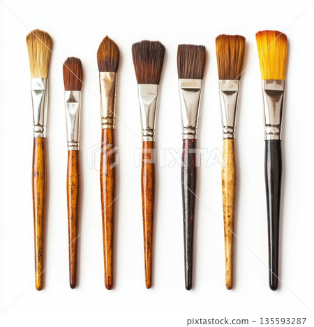 Various paintbrushes arranged in a row showcasing different sizes and bristle types for artists and craft enthusiasts 135593287