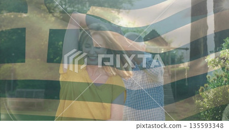 Dancing senior man and adult woman twirling on paved garden path, with benches and stone steps Dancing senior man and adult woman twirling on paved garden path, with benches and stone steps 135593348