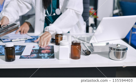 Doctor Explaining X-Ray Results to a Patient Using a Digital Device Doctor Explaining X-Ray Results to a Patient Using a Digital Device 135594403