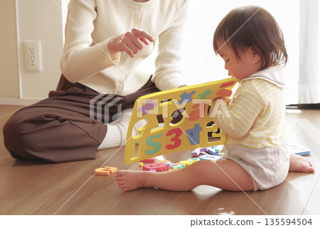 Mother and child having fun playing with toys for toddlers Mother and child having fun playing with toys for toddlers 135594504