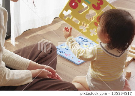 Mother and child having fun playing with toys for toddlers Mother and child having fun playing with toys for toddlers 135594517