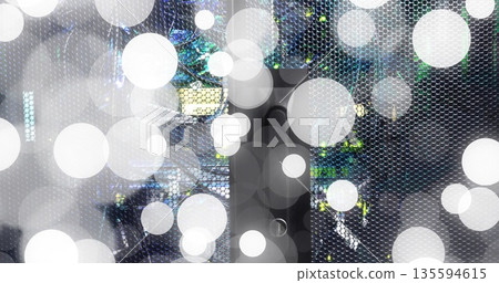 Glowing perforated mesh panel in server rack showing LED indicator lights with circular overlays Glowing perforated mesh panel in server rack showing LED indicator lights with circular overlays 135594615